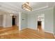 Open living room with hardwood floors and view of foyer and kitchen at 10611 Proposal Pointe Way, Fishers, IN 46040