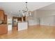 Open concept living space with wood floors, kitchen with breakfast bar, and great natural light at 10611 Proposal Pointe Way, Fishers, IN 46040