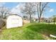 Spacious backyard with a shed, green grass, and fencing at 107 Northwood Dr, Fishers, IN 46038