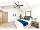 Well-lit bedroom featuring a vaulted ceiling, a ceiling fan and comfortable furnishings at 107 Northwood Dr, Fishers, IN 46038