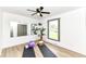 Converted bedroom with vinyl flooring, ceiling fan, yoga mat and a large mirror at 107 Northwood Dr, Fishers, IN 46038