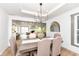 Open-concept dining room with modern chandelier and view of the living room at 107 Northwood Dr, Fishers, IN 46038