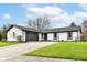 Charming one-story home featuring a brick facade, attached garage, well-maintained landscaping, and inviting curb appeal at 107 Northwood Dr, Fishers, IN 46038