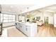 Modern kitchen with a large island, stainless appliances, and adjacent living area at 107 Northwood Dr, Fishers, IN 46038
