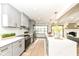 Bright kitchen with white quartz counters, gray cabinetry and stainless appliances at 107 Northwood Dr, Fishers, IN 46038