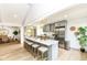 Modern eat-in kitchen featuring an island with seating, stainless steel appliances, and contemporary lighting at 107 Northwood Dr, Fishers, IN 46038