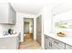 Stylish kitchen featuring white and grey color scheme, cabinetry and white counter tops at 107 Northwood Dr, Fishers, IN 46038
