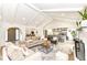 Bright, open-concept living room with vaulted ceilings, fireplace, hardwood floors, and seamless flow to the dining and kitchen at 107 Northwood Dr, Fishers, IN 46038