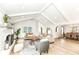 Bright, open-concept living room with vaulted ceilings, fireplace, hardwood floors, and seamless flow to the dining room at 107 Northwood Dr, Fishers, IN 46038