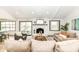 Bright, open-concept living room with vaulted ceilings, fireplace, hardwood floors, and seamless flow to the backyard at 107 Northwood Dr, Fishers, IN 46038