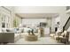 Bright, airy living room with white sectional sofa, contemporary furnishings, and large windows at 11683 Aubrey Ln, Fishers, IN 46040
