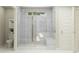 A modern bathroom features a glass-enclosed shower with light gray tile, complemented by a built-in bench at 11683 Aubrey Ln, Fishers, IN 46040