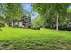 Lush backyard with manicured lawn, mature trees and foliage at 11974 Volcanic Rock Dr, Fishers, IN 46037