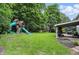 Spacious backyard featuring a playset and covered patio at 11974 Volcanic Rock Dr, Fishers, IN 46037