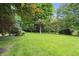 Expansive backyard with lush green grass, mature trees, and ample space for outdoor activities at 11974 Volcanic Rock Dr, Fishers, IN 46037