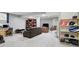 Spacious finished basement with comfortable seating, entertainment area, and custom shelving for storage at 11974 Volcanic Rock Dr, Fishers, IN 46037