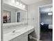 Bright bathroom with a large mirror, modern vanity, and a view into the bedroom at 11974 Volcanic Rock Dr, Fishers, IN 46037