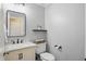 Powder room featuring a modern vanity with marble countertop and decorative mirror at 11974 Volcanic Rock Dr, Fishers, IN 46037
