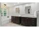 Bathroom featuring double vanity sinks, granite countertops, and a separate soaking tub at 11974 Volcanic Rock Dr, Fishers, IN 46037
