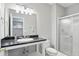 Clean bathroom with a vanity, large mirror, and a shower with sliding glass doors at 11974 Volcanic Rock Dr, Fishers, IN 46037
