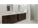 Modern bathroom with double vanities, granite countertops, tile backsplash, and a walk-in closet at 11974 Volcanic Rock Dr, Fishers, IN 46037