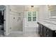 Bright bathroom with a tiled shower, soaking tub, and a vanity with granite countertop at 11974 Volcanic Rock Dr, Fishers, IN 46037