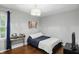 This bedroom features hardwood floors, a cozy bed, a desk, and a bright window at 11974 Volcanic Rock Dr, Fishers, IN 46037
