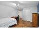 This bedroom features hardwood floors, a desk, a dresser, and ample closet space at 11974 Volcanic Rock Dr, Fishers, IN 46037