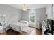 This bedroom features a cozy bed, hardwood floors, and a window with natural light at 11974 Volcanic Rock Dr, Fishers, IN 46037