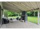Inviting covered patio with a stone fireplace, comfortable seating, and ambient string lights at 11974 Volcanic Rock Dr, Fishers, IN 46037
