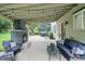 Inviting covered patio with a stone fireplace, comfortable seating, and ambient string lights; perfect for relaxation at 11974 Volcanic Rock Dr, Fishers, IN 46037