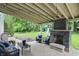 Inviting covered patio with a stone fireplace, comfortable seating, and ambient string lights at 11974 Volcanic Rock Dr, Fishers, IN 46037