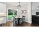 Bright dining area with modern lighting, hardwood floors, and sliding door access to the yard at 11974 Volcanic Rock Dr, Fishers, IN 46037