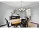 Cozy dining room with a dark wood buffet cabinet, chandelier, and six person table at 11974 Volcanic Rock Dr, Fishers, IN 46037