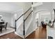 Inviting foyer with hardwood floors, staircase, and arched doorway to the living room at 11974 Volcanic Rock Dr, Fishers, IN 46037