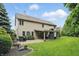 Beautiful home exterior with a covered patio featuring an outdoor fireplace, and manicured lawn at 11974 Volcanic Rock Dr, Fishers, IN 46037