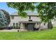 Beautiful home exterior with a covered patio featuring an outdoor fireplace, and manicured lawn at 11974 Volcanic Rock Dr, Fishers, IN 46037