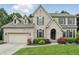 Stunning two-story brick home features an attached garage and inviting front yard landscaping at 11974 Volcanic Rock Dr, Fishers, IN 46037