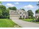 Charming brick home with an attached garage, lush landscaping, and a long driveway at 11974 Volcanic Rock Dr, Fishers, IN 46037
