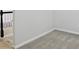 Hallway with light grey carpet and white trim; open to staircase with black handrail at 11974 Volcanic Rock Dr, Fishers, IN 46037