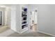 Bright hallway features built-in shelving and leads to additional rooms at 11974 Volcanic Rock Dr, Fishers, IN 46037