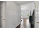 Bright hallway leading to the main bedroom, featuring hardwood floors and neutral paint at 11974 Volcanic Rock Dr, Fishers, IN 46037
