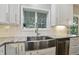 Modern kitchen featuring farmhouse sink, stainless steel appliances, and white subway tile backsplash is a chef's dream at 11974 Volcanic Rock Dr, Fishers, IN 46037