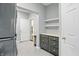 Clean laundry room with gray cabinets, drawers, and a view through to another room at 11974 Volcanic Rock Dr, Fishers, IN 46037
