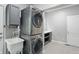 Efficient laundry room with stacked washer/dryer, ample countertop space, and utility sink at 11974 Volcanic Rock Dr, Fishers, IN 46037