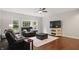Cozy living room with a large leather sofa, hardwood floors, and bright windows offering comfortable seating at 11974 Volcanic Rock Dr, Fishers, IN 46037