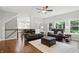 Spacious living room featuring hardwood floors, leather seating, bright windows, and open floor plan at 11974 Volcanic Rock Dr, Fishers, IN 46037