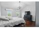 This main bedroom features hardwood floors, vaulted ceilings, TV, dresser, and bright windows at 11974 Volcanic Rock Dr, Fishers, IN 46037