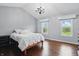 This main bedroom boasts hardwood floors, two windows, vaulted ceiling, and a modern chandelier at 11974 Volcanic Rock Dr, Fishers, IN 46037