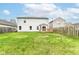 Spacious backyard featuring a wooden deck and ample green space surrounded by a wooden privacy fence at 12455 Deerview Dr, Noblesville, IN 46060
